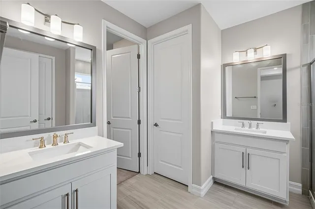 a bathroom with a sink double vanity and a mirror