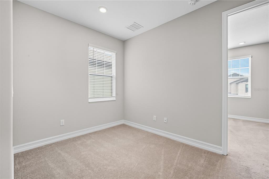 4663 Almada Lane Wesley Chapel, FL 33543 - Photo 16 of 30 an empty room with windows