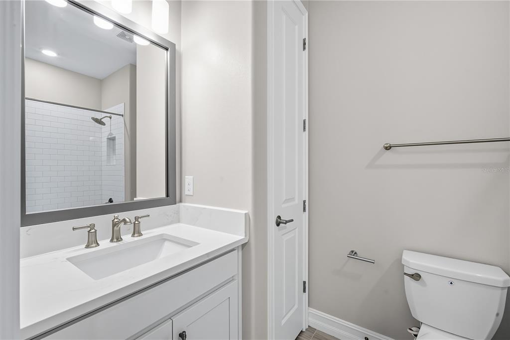 4663 Almada Lane Wesley Chapel, FL 33543 - Photo 18 of 30 a bathroom with a sink toilet vanity and shower