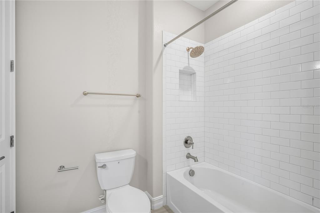4663 Almada Lane Wesley Chapel, FL 33543 - Photo 19 of 30 a white toilet sitting next to a bath tub