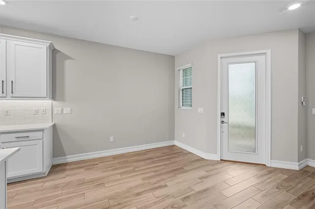 an empty room with wooden floor