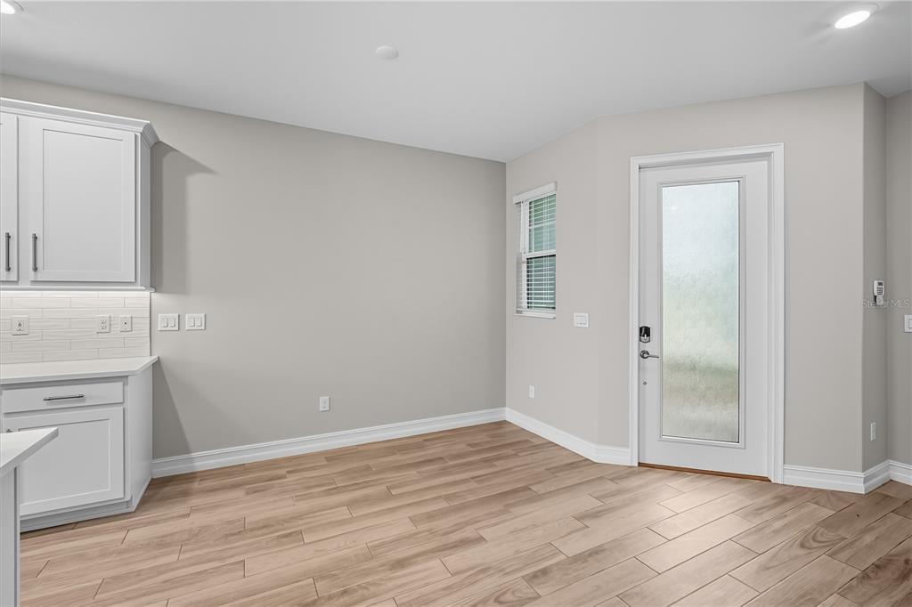 4663 Almada Lane Wesley Chapel, FL 33543 - Photo 4 of 30 an empty room with wooden floor