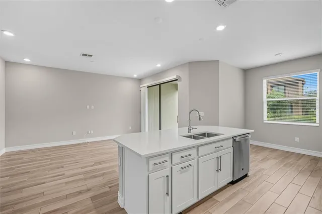 a bathroom with a granite countertop sink a mirror and a window