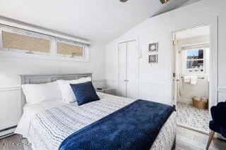 a bedroom with a large bed and a couch