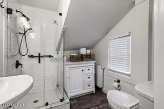 a bathroom with a granite countertop sink toilet and shower