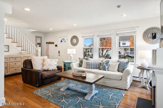 220 13th Avenue Belmar, NJ 07719 - Photo 8 of 21 a living room with fireplace furniture and a large window