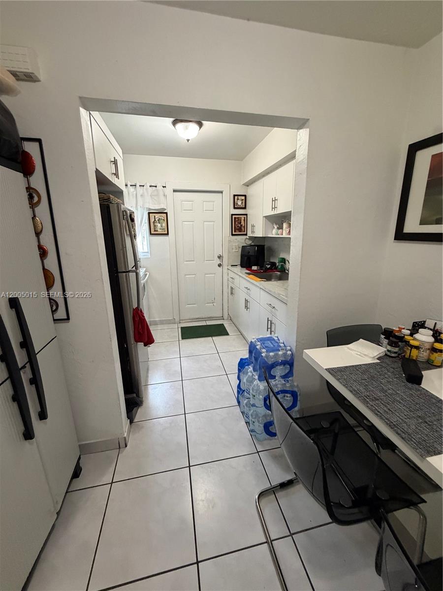 3361 Southwest 28th Street Miami, FL 33133 - Photo 11 of 17 a kitchen with furniture a refrigerator and a stove