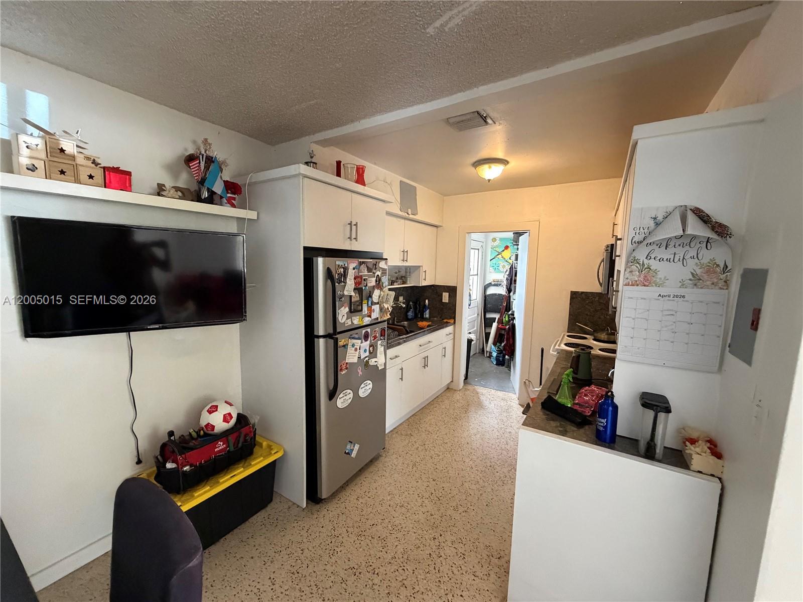3361 Southwest 28th Street Miami, FL 33133 - Photo 3 of 17 a living room with furniture and a flat screen tv