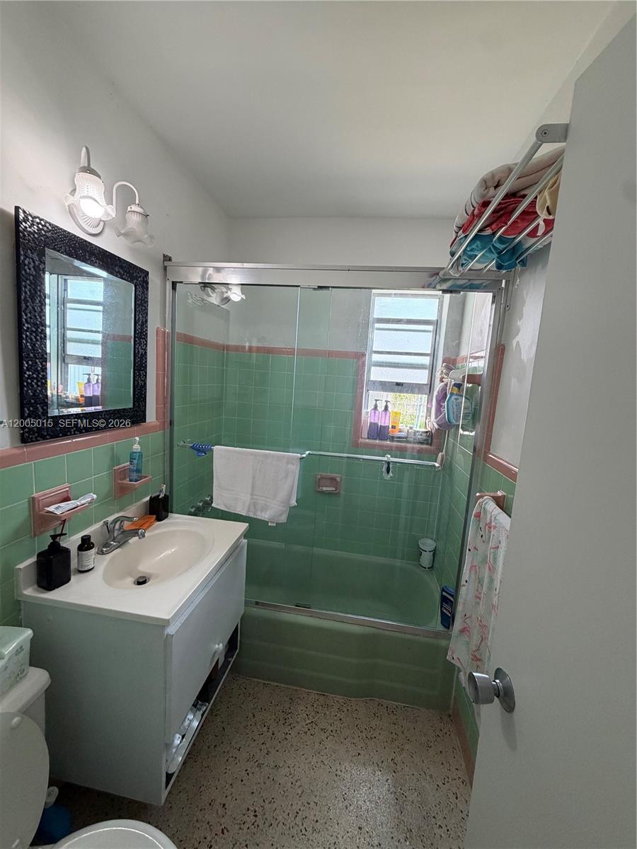 3361 Southwest 28th Street Miami, FL 33133 - Photo 6 of 17 a bathroom with a sink a toilet and a mirror