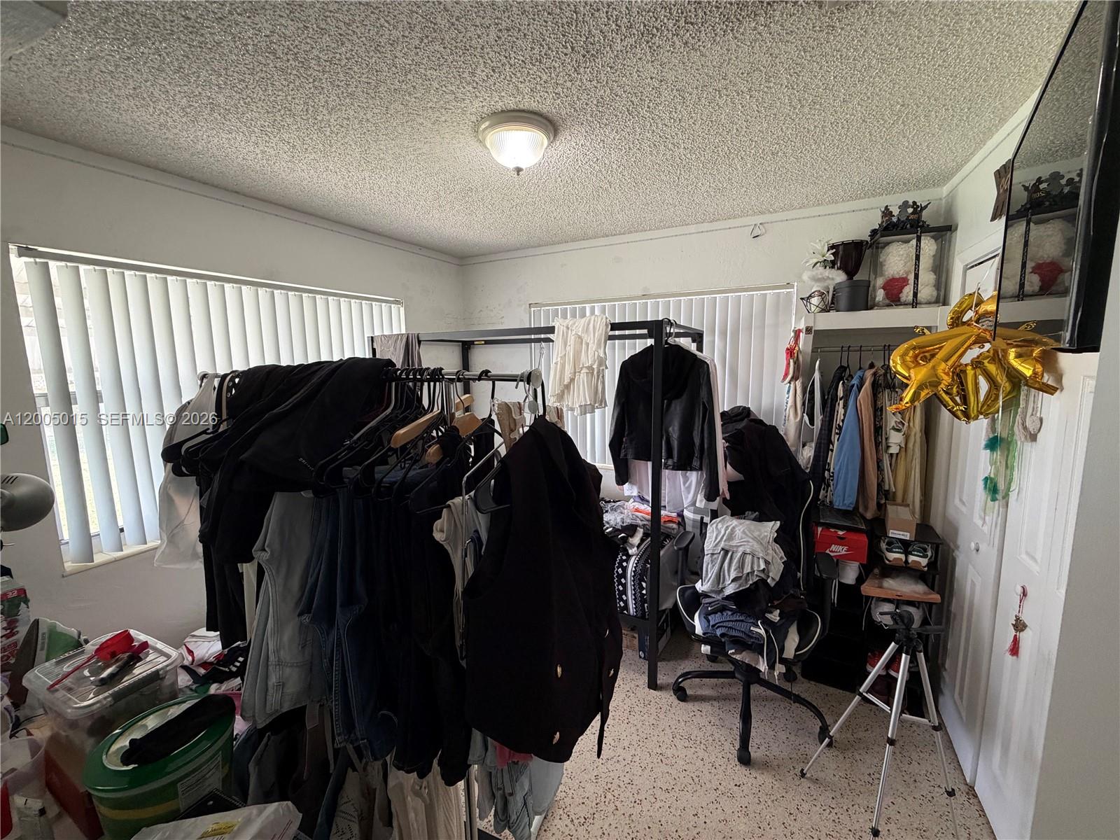 3361 Southwest 28th Street Miami, FL 33133 - Photo 7 of 17 a view of walk in closet with clothes and shoes