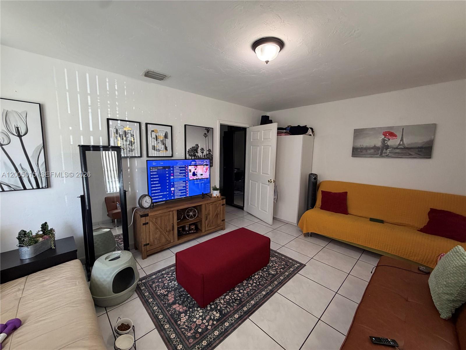 3361 Southwest 28th Street Miami, FL 33133 - Photo 9 of 17 a living room with furniture and a flat screen tv