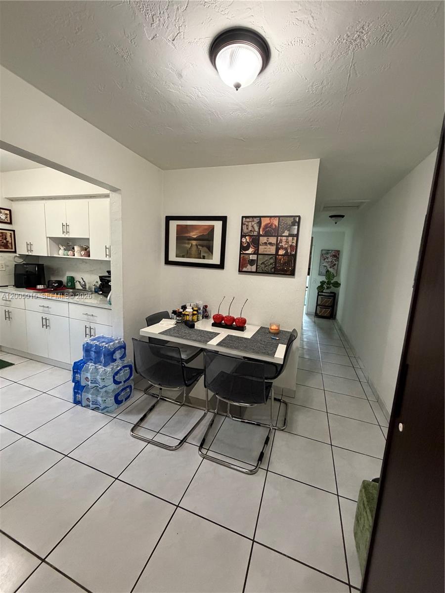 3361 Southwest 28th Street Miami, FL 33133 - Photo 10 of 17 a living room with furniture and a flat screen tv
