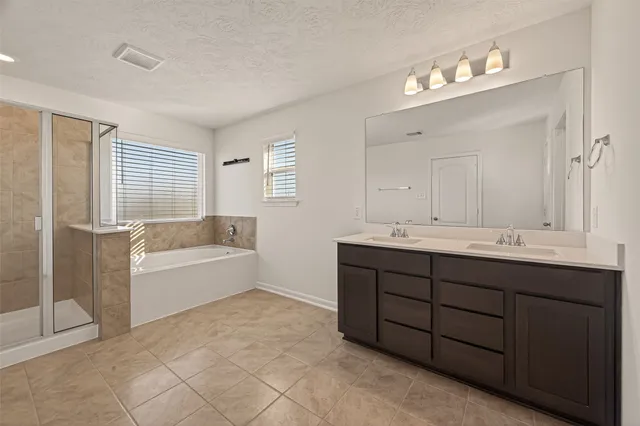 a bathroom with a tub sink and mirror