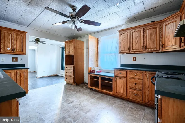 a kitchen with stainless steel appliances granite countertop a stove sink and cabinets