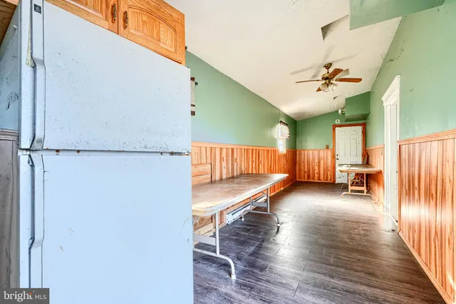 a view of a room with wooden floor and windows
