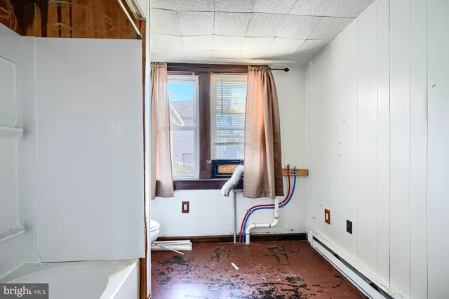a bathroom with a tub a sink and a large mirror