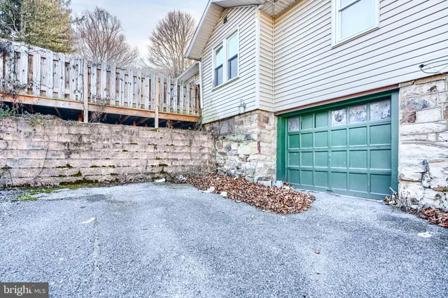 a view of a chair and table in backyard of house
