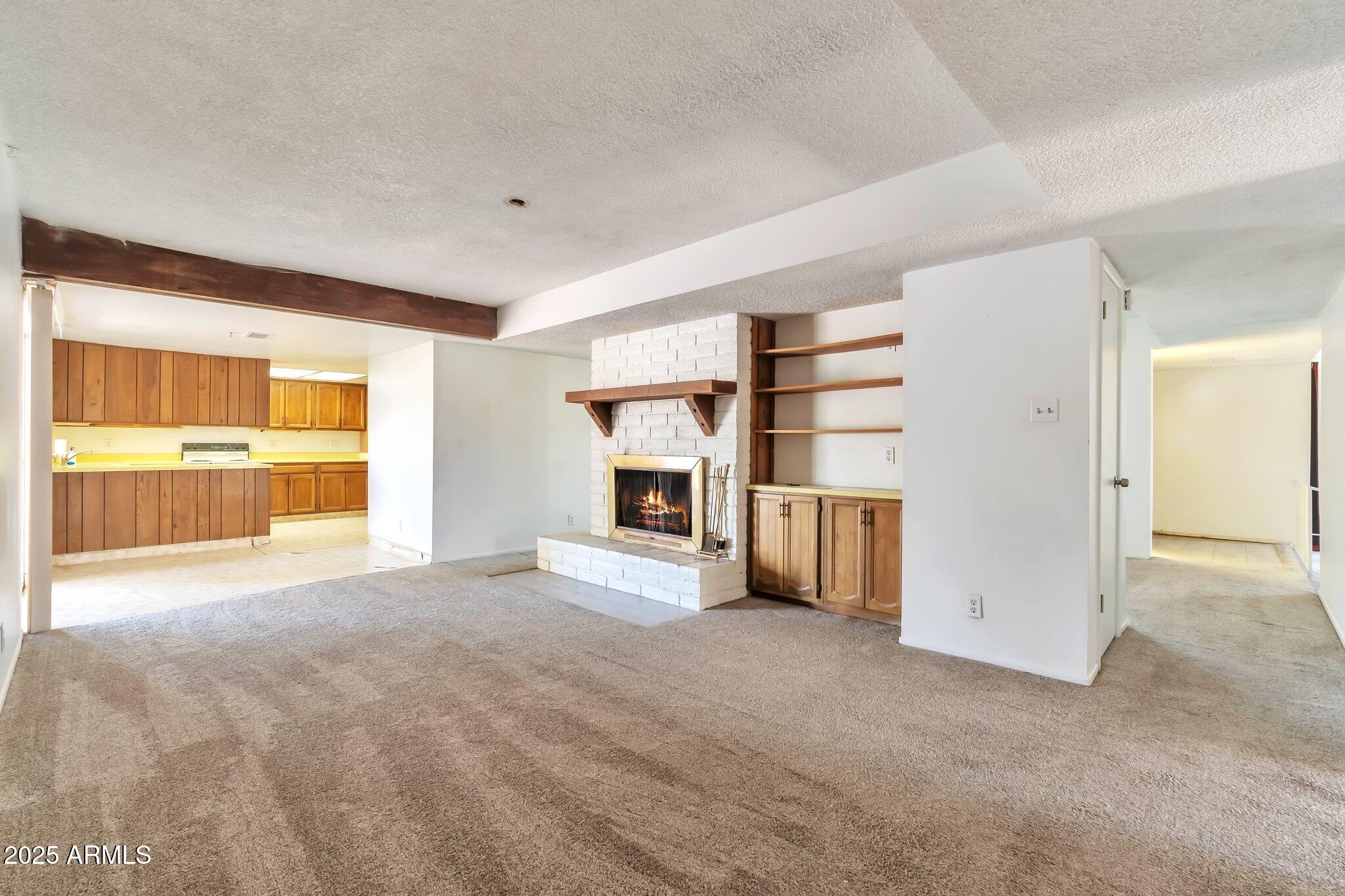 504 North Emerson Mesa, AZ 85201 - Photo 7 of 19 an empty room with a fireplace and cabinet