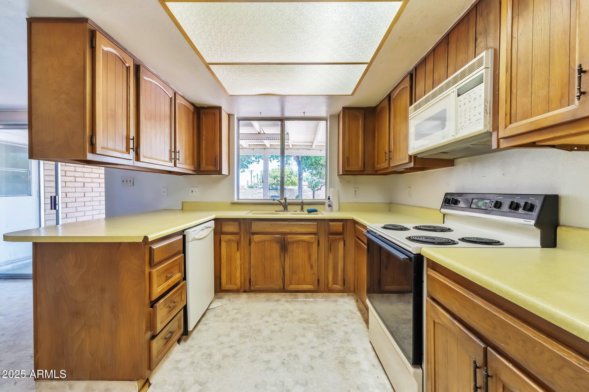 504 North Emerson Mesa, AZ 85201 - Photo 8 of 19 a kitchen with stainless steel appliances granite countertop a sink and cabinets