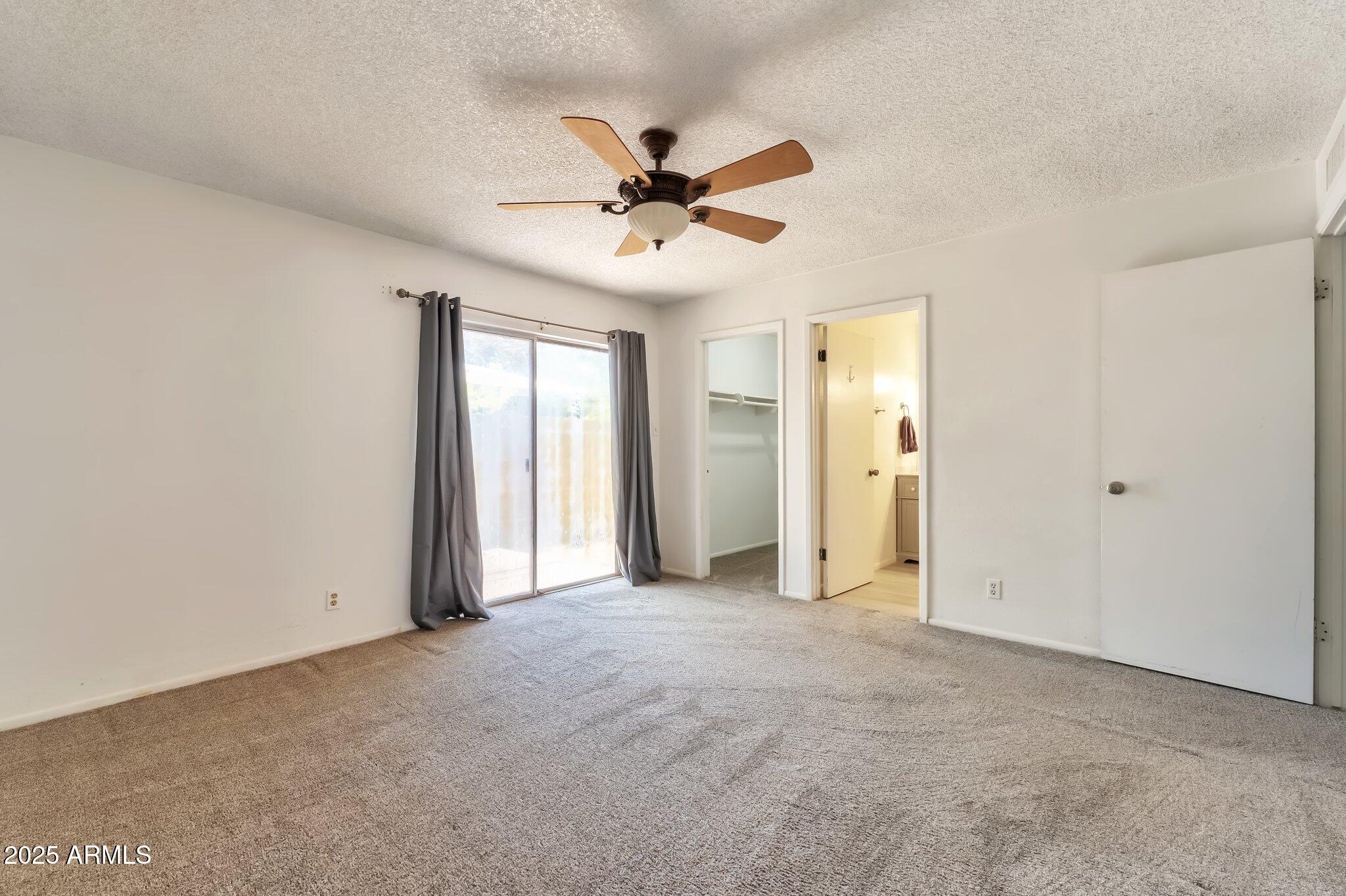 504 North Emerson Mesa, AZ 85201 - Photo 9 of 19 an empty room with ceiling fan and window