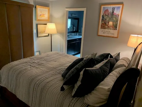 a bedroom with a bed and a lamp