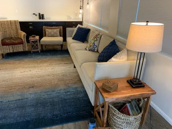 a living room with furniture and a lamp