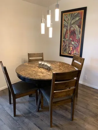 a view of a dining room with furniture and wooden floor