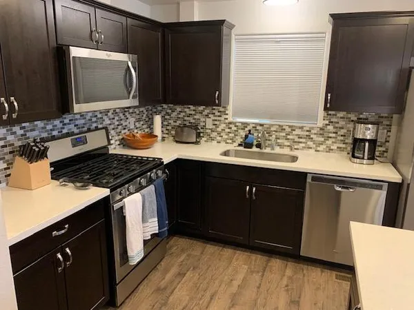a kitchen with a sink and a stove