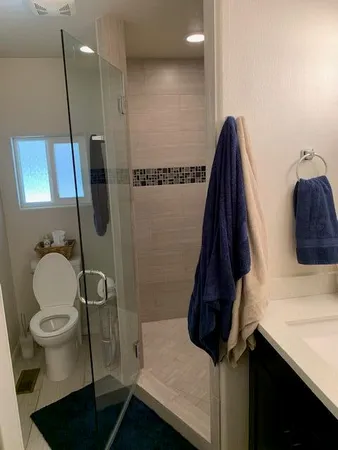 a bathroom with a toilet and a shower