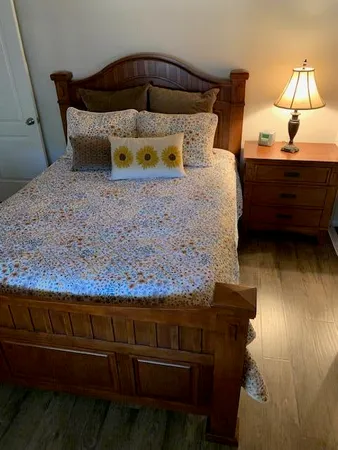 a bed sitting in a bedroom next to a lamp