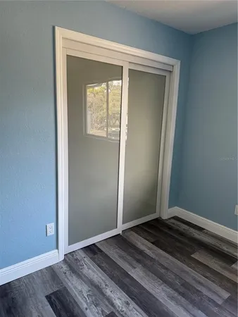 a view of an empty room and wooden floor