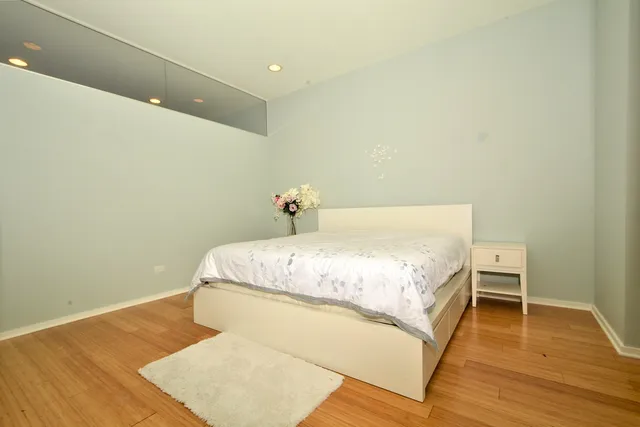 a bedroom with a bed and a chandelier