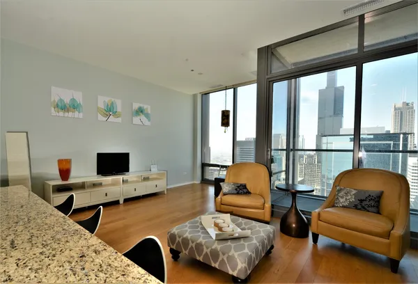 a bedroom with furniture and a large window