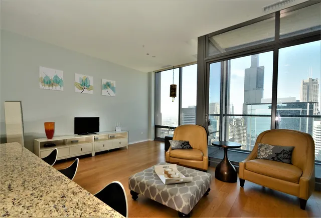 a bedroom with furniture and a large window