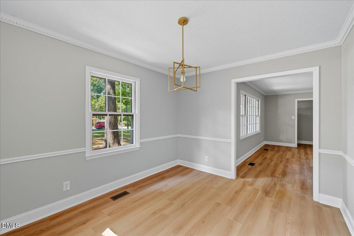 1214 East Oak Drive Durham, NC 27712 - Photo 11 of 36 wooden floor in an empty room with a window