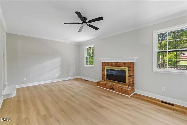 a view of a livingroom with a fireplace and window