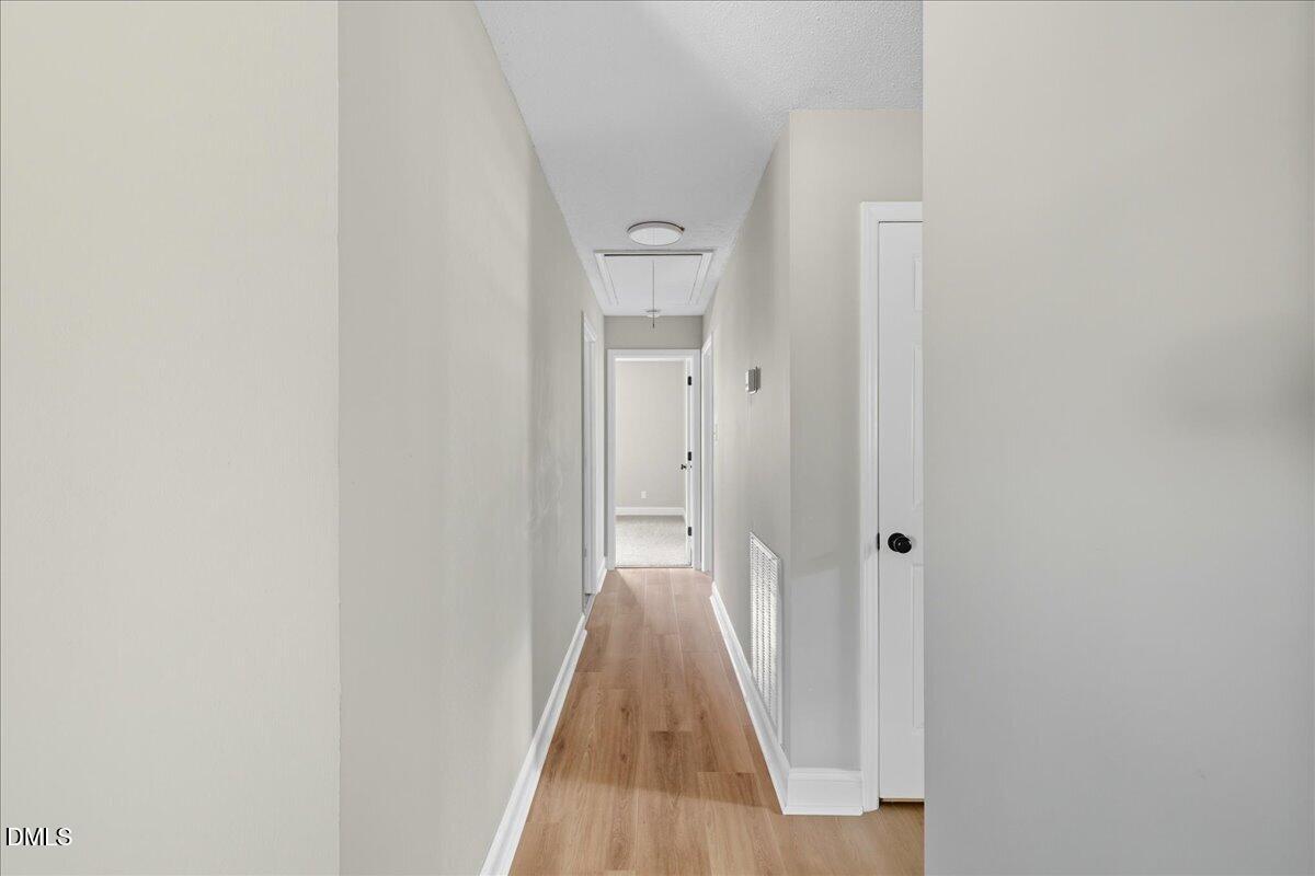 1214 East Oak Drive Durham, NC 27712 - Photo 21 of 36 a view of a hallway with wooden floor and a door