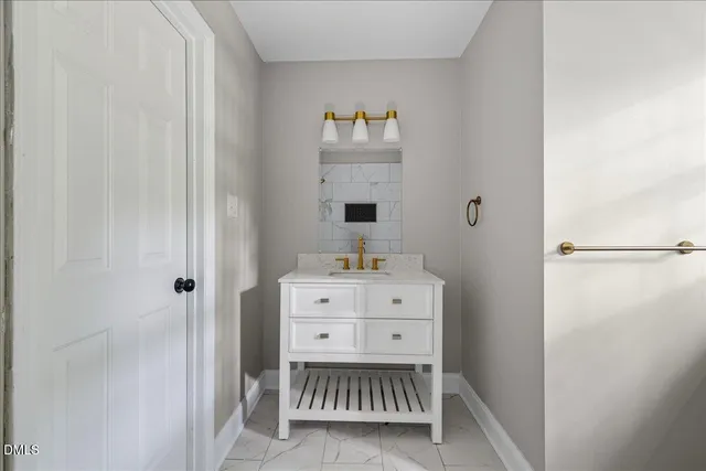 a room with a baby crib and a dresser