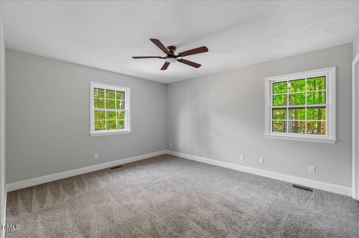 1214 East Oak Drive Durham, NC 27712 - Photo 26 of 36 an empty room with a window and a fan