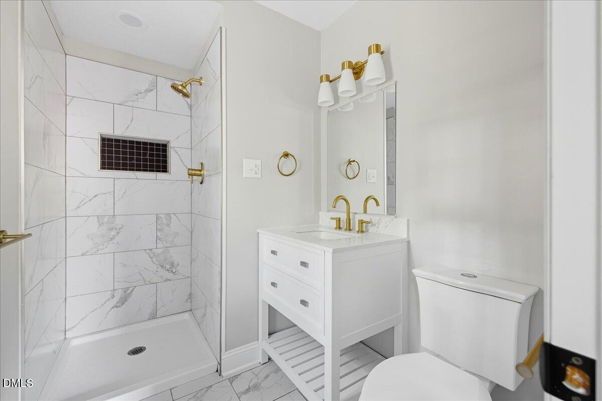 1214 East Oak Drive Durham, NC 27712 - Photo 28 of 36 a bathroom with a sink a toilet and shower