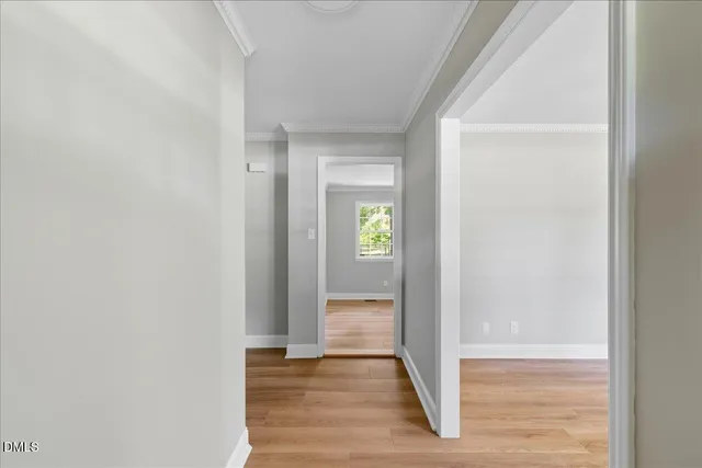 a view of a hallway with wooden floor