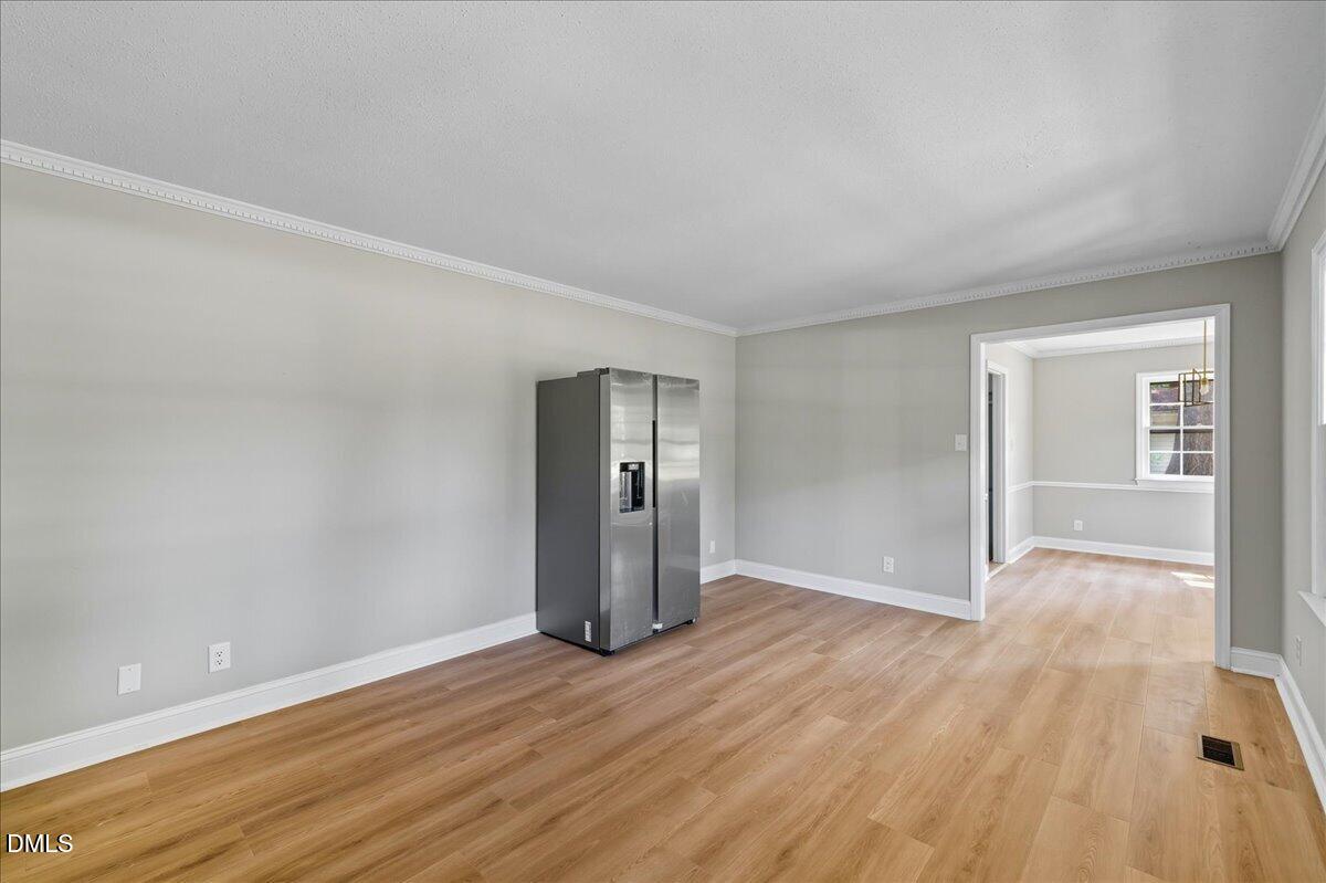 1214 East Oak Drive Durham, NC 27712 - Photo 6 of 36 wooden floor in an empty room with a window