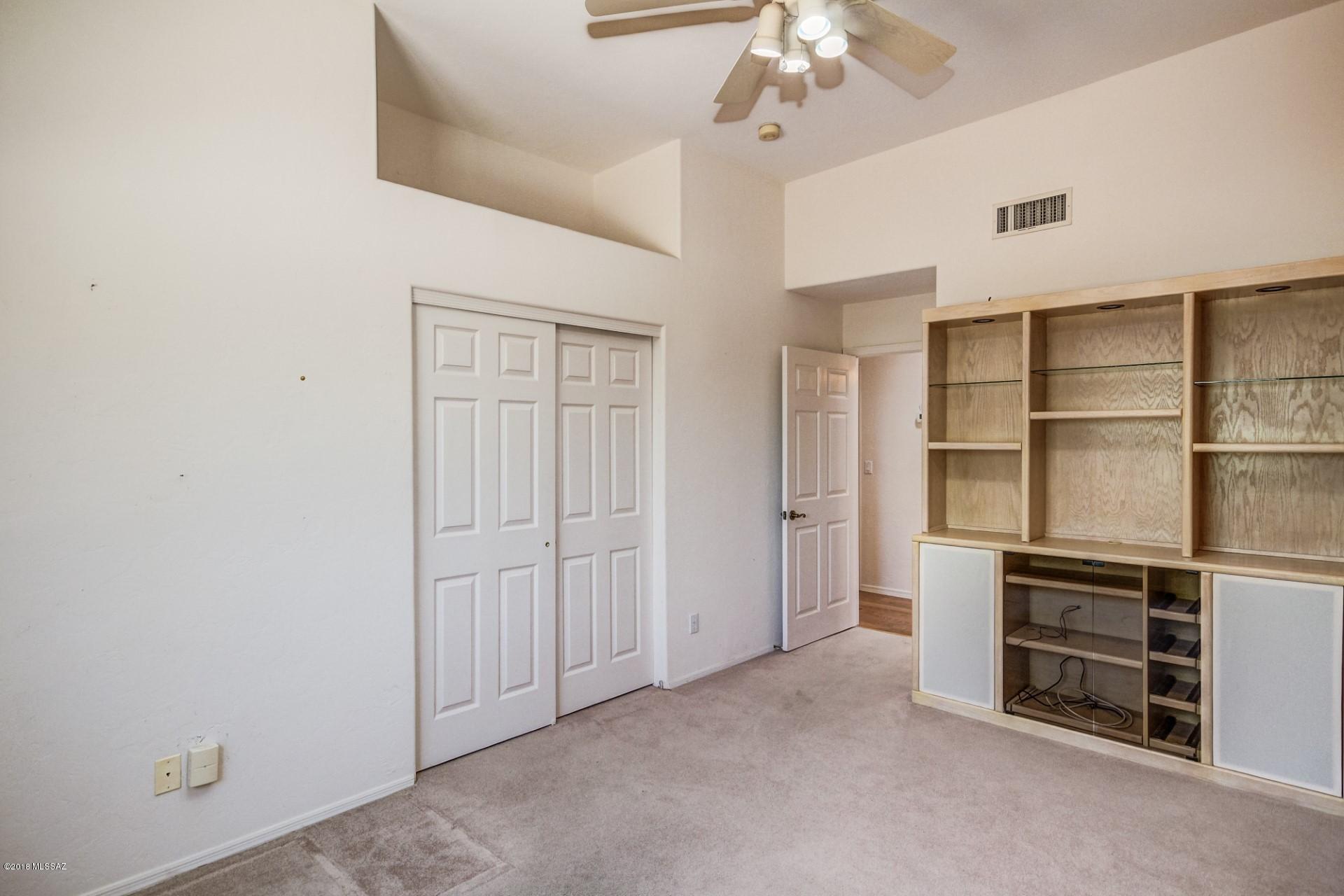 14480 North Swan Road Tucson, AZ 85739 - Photo 22 of 31 a view of walk in closet with empty racks