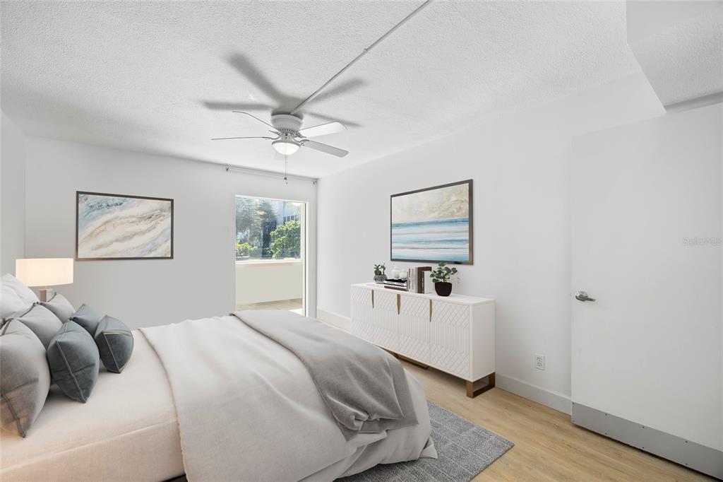 9950 47th Avenue North, Unit 104 St. Petersburg, FL 33708 - Photo 15 of 37 a bedroom with a white bed and a window