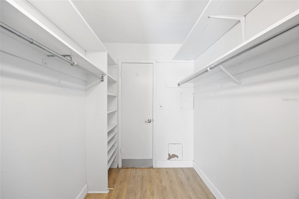 9950 47th Avenue North, Unit 104 St. Petersburg, FL 33708 - Photo 20 of 37 a view of walk in closet with empty racks