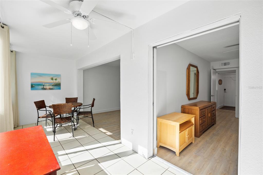 9950 47th Avenue North, Unit 104 St. Petersburg, FL 33708 - Photo 22 of 37 a dining room with furniture and wooden floor