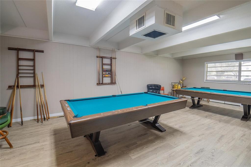 9950 47th Avenue North, Unit 104 St. Petersburg, FL 33708 - Photo 35 of 37 a room with pool tables and windows