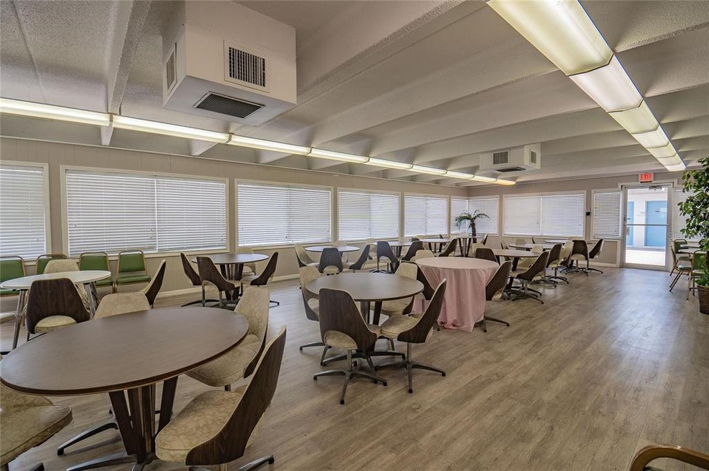 9950 47th Avenue North, Unit 104 St. Petersburg, FL 33708 - Photo 37 of 37 a living room with lots of chairs and a table