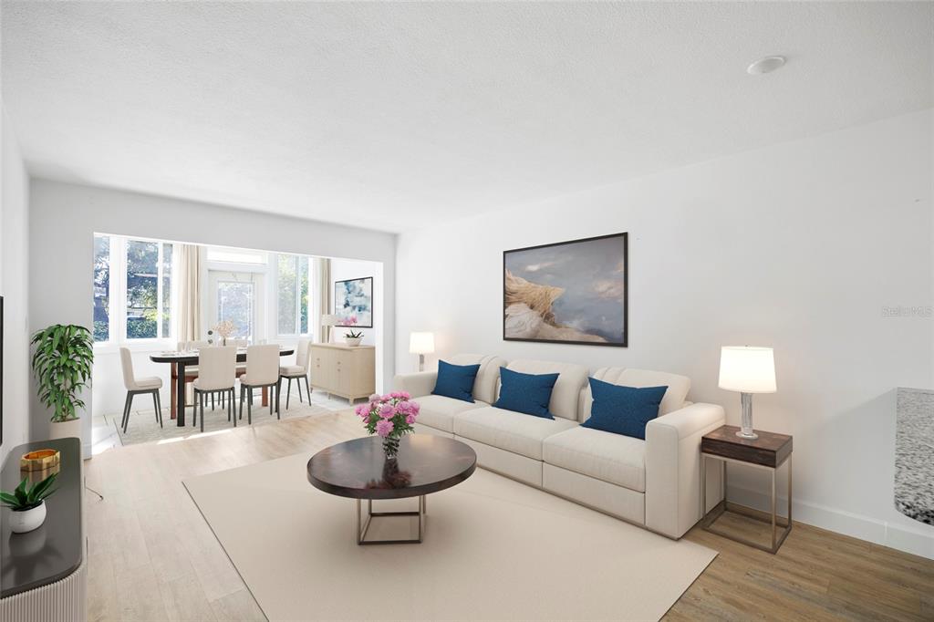 9950 47th Avenue North, Unit 104 St. Petersburg, FL 33708 - Photo 4 of 37 a living room with furniture and wooden floor
