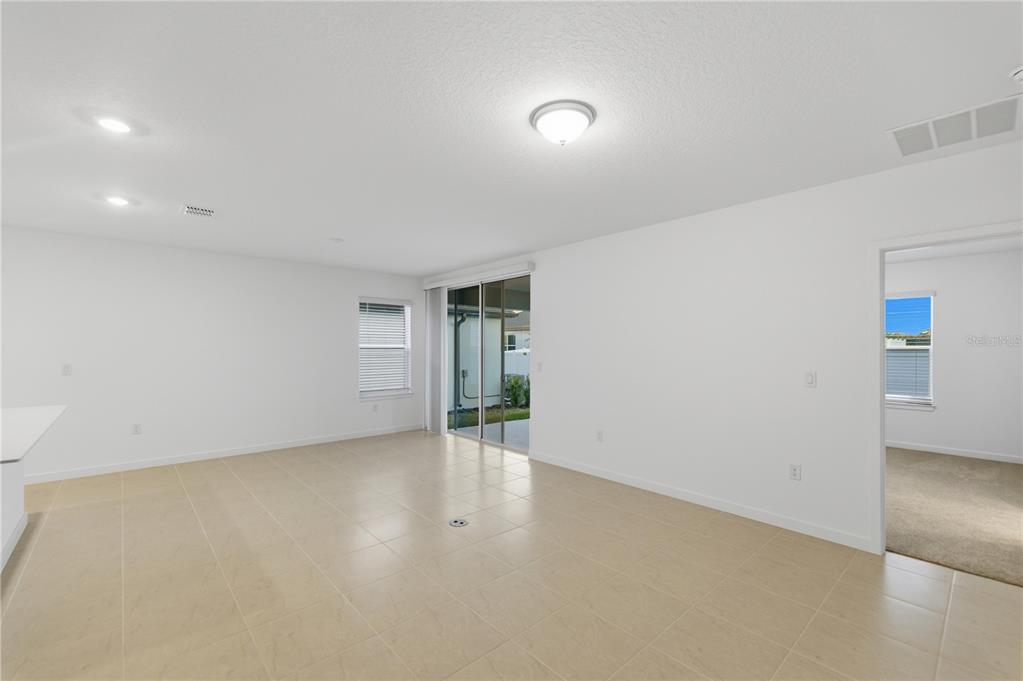 6760 Southwest 90th Loop Ocala, FL 34476 - Photo 13 of 28 an empty room with an empty space and wooden floor